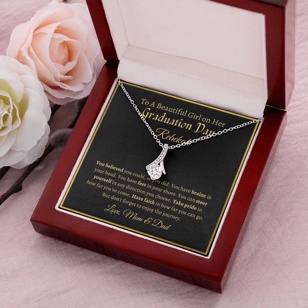 To A Beautiful Girl On Her Graduation Day -  Ribbon Necklace - Love Mom & Dad Alluring Beauty Necklace